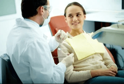 Dentist working on womans teeth