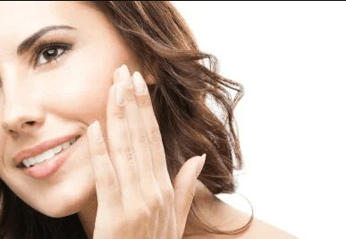 woman touching face smiling