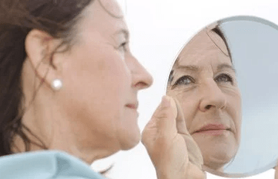 older woman looking in the mirror