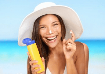 woman on the beach with sunscreen