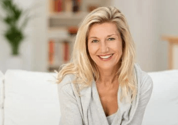 woman smiling sitting on couch